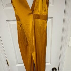 This beautiful gold one shoulder dress with slit in front is the perfect dress.